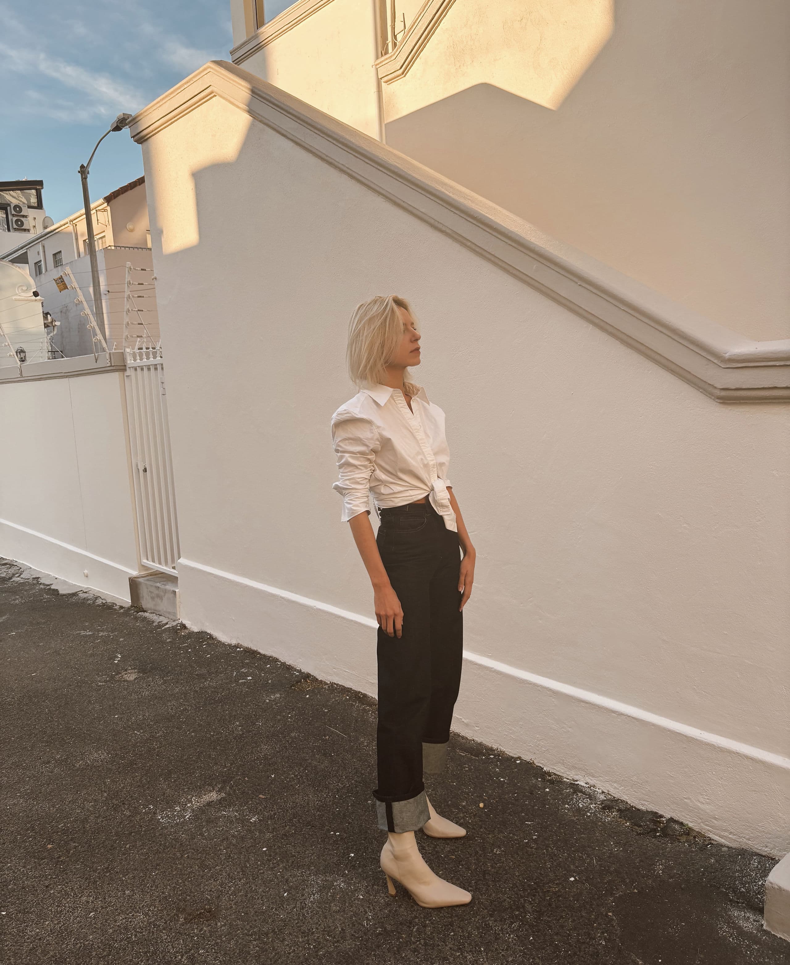 State of Dominion dark denim with a white shirt, photographed in South Africa